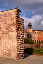 Fragment of a medieval defensive wall and red brick buildings Royalty Free Stock Photo