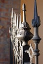 A fragment of a metal fence with close-up details. Forged fence of the entrance of church. Royalty Free Stock Photo