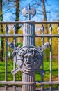 Fragment of a metal fence of the Summer Garden in St. Petersburg decorated with the image of the face of the Gorgon Medusa on the Royalty Free Stock Photo