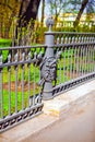 A fragment of the metal fence of the Summer garden in St. Petersburg decorated with the image of the face of Medusa Gorgon on the Royalty Free Stock Photo