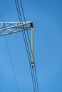 Fragment of metal pole of high-voltage power line VL-750 kV with insulators and cables against blue sky. Garlands of insulators Royalty Free Stock Photo