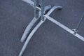 Fragment of a metal portable barrier standing on the asphalt Royalty Free Stock Photo