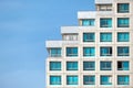 fragment of a modern building against the blue daytime sky. the building is built on the principle of stairs. Royalty Free Stock Photo