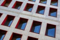 Fragment of modern building facade with red window frames