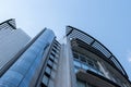 Fragment of a modern high-rise building of glass and concrete against a blue sky Royalty Free Stock Photo