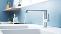 Fragment of a modern luxury kitchen with blue wall on the background. White stone countertop with double built-in sink Royalty Free Stock Photo