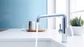 Fragment of a modern luxury kitchen with light blue wall and window on the background. White stone countertop with built Royalty Free Stock Photo