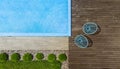 Fragment of modern luxury pool and wooden terrace. Landscaping background. Top view