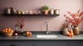 Fragment of modern minimalist kitchen. Gray stone countertop with built-in sink and metallic faucet. Peach tone wall