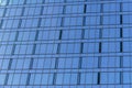 Fragment of a modern office building. Abstract geometric background. Facade of a skyscraper with glass windows. Royalty Free Stock Photo