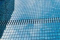 Fragment of a modern office building. Abstract geometric background. Part of a skyscraper with glass windows. Royalty Free Stock Photo