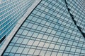 Fragment of a modern office building. Abstract geometric background. Part of a skyscraper with glass windows. Royalty Free Stock Photo