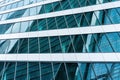 Fragment of a modern office building. Abstract geometric background. Part of a skyscraper with glass windows. Royalty Free Stock Photo