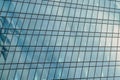 Fragment of a modern office building. Abstract geometric background. Part of a skyscraper with glass windows. Royalty Free Stock Photo