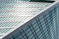 Fragment of a modern office building. Abstract geometric background. Part of a skyscraper with glass windows. Royalty Free Stock Photo