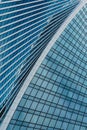 Fragment of a modern office building. Abstract geometric background. Part of a skyscraper with glass windows. Royalty Free Stock Photo