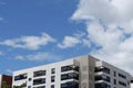 Fragment of modern residential condo buildings exterior. Copy space. Blue sky with vibrant clouds Royalty Free Stock Photo
