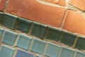 A fragment of a mosaic of the Soviet period made of ceramic tiles. Tiles in orange, green and turquoise colors