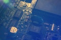 A fragment of a motherboard PCB of a computer hardware with many components. Macro photography of processors and transistors