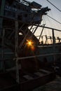 Fragment of a multi-bucket excavator giant against the light against the sunset