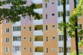 Fragment of multi story apartment building facade, view across trees Royalty Free Stock Photo