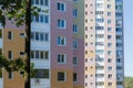 Fragment of multi story apartment building with tree on foreground Royalty Free Stock Photo