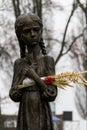 Sculpture of hungry young girl with ears of wheat in their hands. Kiev, Ukraine Royalty Free Stock Photo