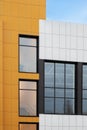 Fragment of new commercial complex. Yellow-brown modern ventilated facade with large windows. Part of urban property Royalty Free Stock Photo