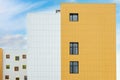 Fragment of new commercial complex. Yellow-white modern ventilated facade with large windows. Part of urban property Royalty Free Stock Photo