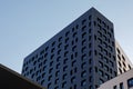 Part of urban real estate. Fragment of a new elite residential building or commercial complex. Black modern ventilated facade with Royalty Free Stock Photo