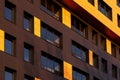 Fragment of a new elite residential building or commercial complex. Part of urban real estate. Yellow-brown modern Royalty Free Stock Photo