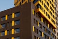 Fragment of a new elite residential building or commercial complex. Part of urban real estate. Yellow-brown modern ventilated Royalty Free Stock Photo