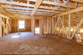 Fragment of a new home under construction wood framing beams