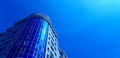 Fragment of a new, modern building with windows and blue stained-glass windows. Royalty Free Stock Photo