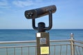 A fragment of observation binoculars against the background of the Baltic Sea. Zelenogradsk, Kaliningrad region. Russian text