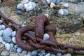 Fragment of old anchor chain on stone background. Marine theme and style. Royalty Free Stock Photo