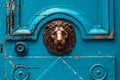 The fragment of an old blue medieval door decorated lion Royalty Free Stock Photo