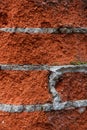 fragment of an old brick wall made of red brick and cement mortar Royalty Free Stock Photo