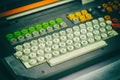 Fragment of an old computer keyboard with round buttons, toning close-up