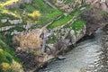 Fragment of an old concrete staircase on the rocky bank of the river. An old abandoned river pier Royalty Free Stock Photo