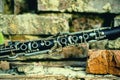 Fragment of an old and dirty magic clarinet on a background of broken brick wall as symbol of beautiful classical music Royalty Free Stock Photo