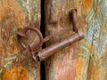 Fragment of an old door locked to a home-made castle in the stone house of the mountaineers of the Caucasus Royalty Free Stock Photo