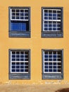 Fragment of the old facade with closed vintage windows. Traditional guillotine windows front view. Four old style blue wooden