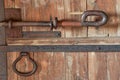 Fragment of an old fortress door with forged metal bolts and locks Royalty Free Stock Photo