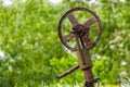 Fragment of old machine. Rusty wheel for belt in unknown mechanism