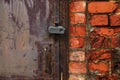 Fragment of an old metal door closed with a lock Royalty Free Stock Photo