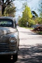 Fragment of an old passenger car on a suburban road. An old rusty automobile. Selective focus