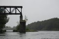 Fragment of the old railway bridge over the river in the fog Royalty Free Stock Photo