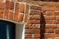 Fragment of an old red brick building. The structure and method of laying the stone around the window. Embossed vintage Royalty Free Stock Photo