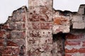 Fragment of an old red brick wall with stains and chips Royalty Free Stock Photo